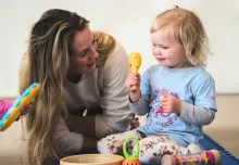 Toddler at Monkey Music class with real musical instruments
